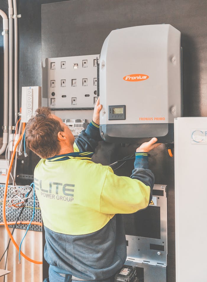 about-07 Expert technician setting up a solar inverter in Thornton, NSW, ensuring efficient solar energy flow.