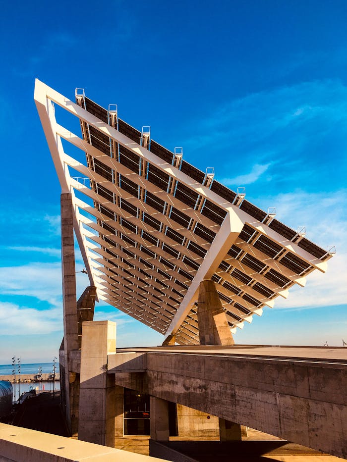 about-05 Photograph of a large solar panel installation set against a clear blue sky, highlighting renewable energy.